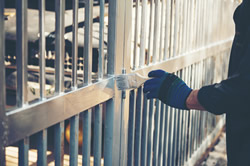 Photo of an iron gate being painted.